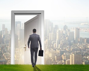 Businessman standing in front of door into future