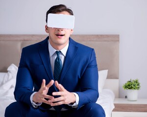 Businessman wearing a virtual reality headset in the bedroom