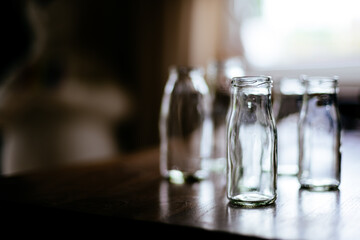 selective focus of empty glass bottle on wooden table