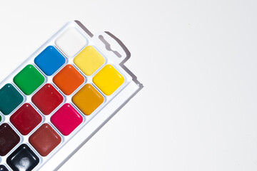 Top view of set of watercolor paints  in a box, isolated on white.