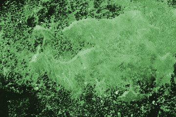 Green ink and watercolor texture on white paper background. Paint leaks and decalcomania effects. Hand-painted gouache abstract image. Mess on the canvas.