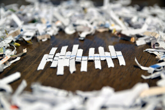 Shredded pieces of paper depicting username and password amongst other pieces of shredded paper