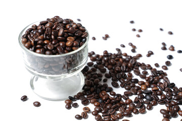 The scattered coffee beans came out of the white cup and formed a coffee writing. Blend of coffee...