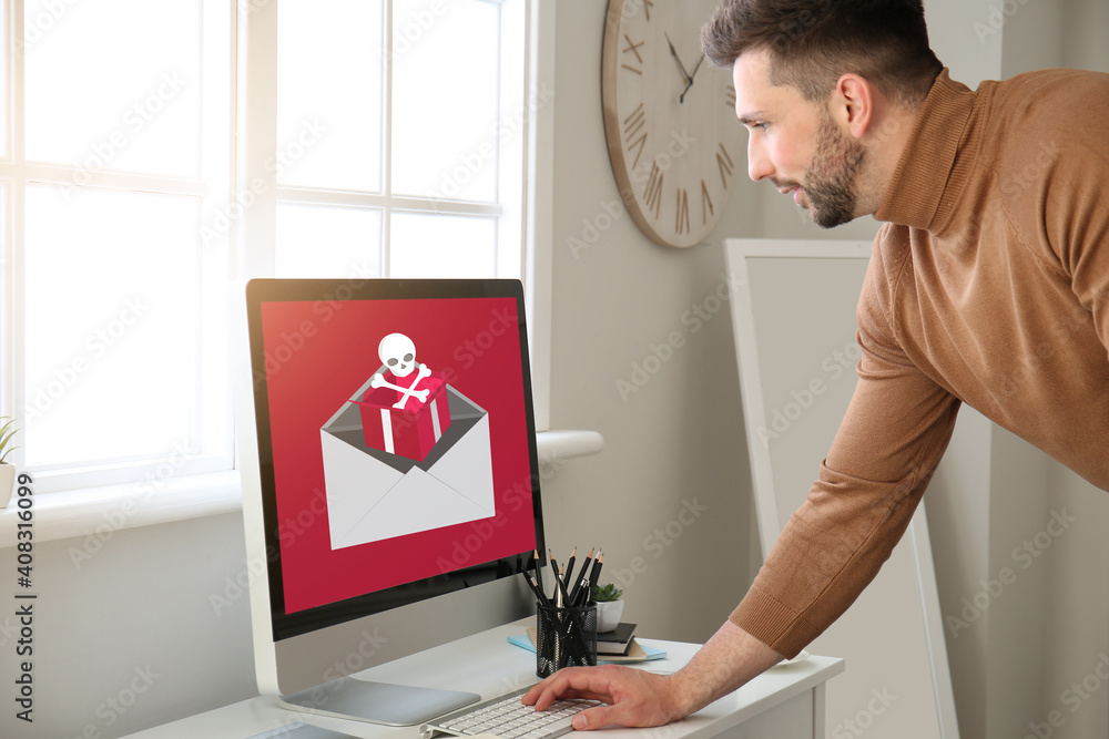 Poster young man with received infected email message on screen of computer at home