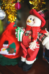 Snowman Santa Claus with gifts under the Christmas tree