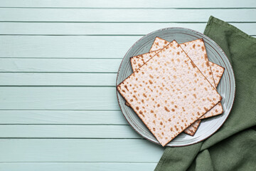 Plate with Jewish flatbread matza for Passover on wooden background