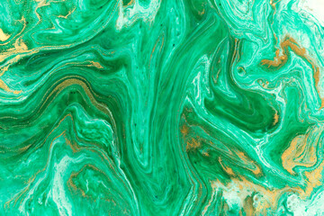 Green marble abstract acrylic background. Marbling artwork texture. Agate ripple pattern. Gold powder.