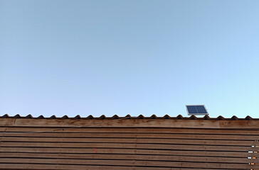 Naklejka premium solar cell or Photovoltaics module (PV module, Solar module) on the roof with blue sky.
