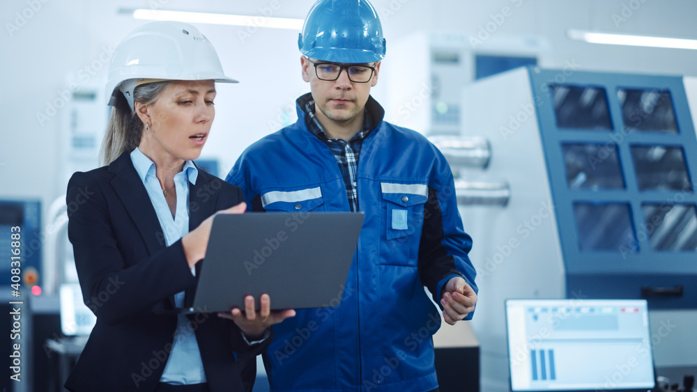 Leinwandbilder female manager and project engineer wearing hardhats use laptop in industrial factory, talk, plan pr