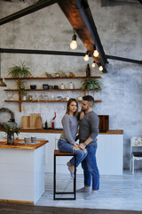 girl and guy in the kitchen hugging