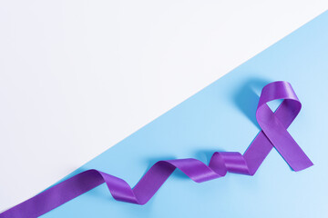 World cancer day, purple ribbon on with and blue background with copy space for text. Healthcare...