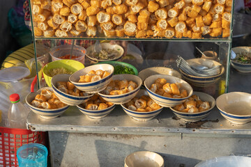 Cut deep-fried bread sticks - youtiao at breakfast stall on the street