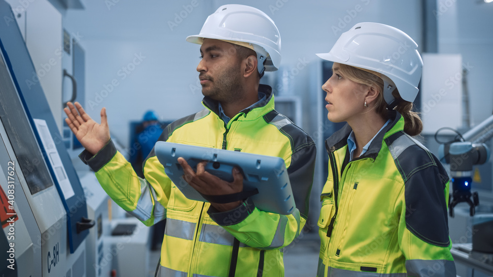 Poster Chief Engineer and Project Manager Wearing Safety Vests and Hard Hats, Use Digital Tablet Controller in Modern Factory, Talking, Optimizing CNC Machinery, Increasing Production Line Efficiency 