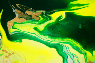 Green and yellow marble abstract acrylic background. Marbling artwork texture. Agate ripple pattern. Gold powder.