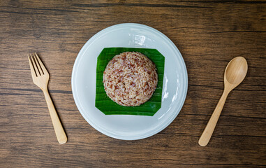 Organic Brown Rice/Coarse rice with wooden spoon and fork on  background. Top view.