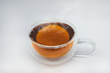 Glass cup of black tea. Isolated on white background