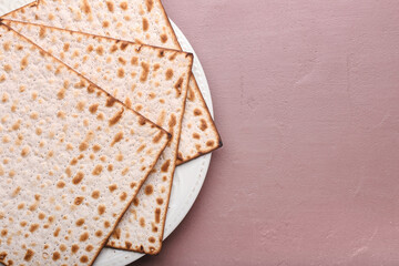 Plate with Jewish flatbread matza for Passover on color background