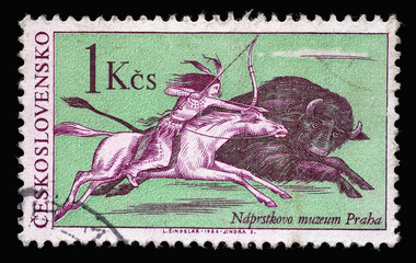 Stamp printed in Czechoslovakia shows the scene of buffalo hunting, a native American Indian on horseback, pursue a bison galloping, circa 1966 - 408319283