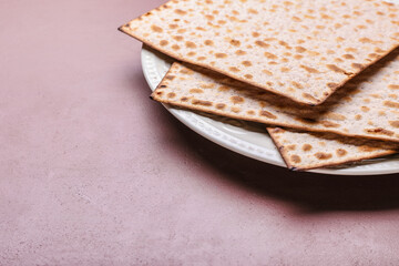 Plate with Jewish flatbread matza for Passover on color background, closeup