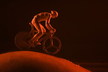 Statue of a cyclist in red light, night photo, lisopark, Kharkiv, Ukraine.