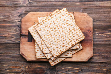 Jewish flatbread matza for Passover on wooden background