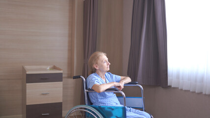 Lonely senior woman lying on Wheelchair