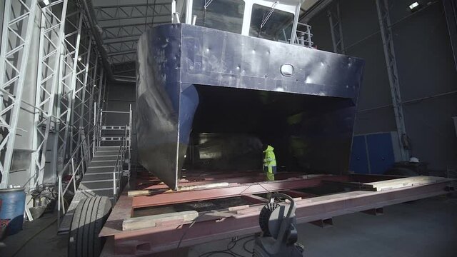 Harbor Worker Working On A Ship At The Shipyard. wide shot