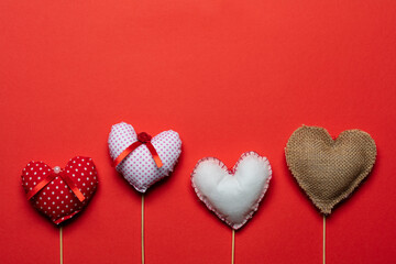 Red textile hearts on wooden sticks for Valentines day background