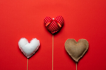 Red textile hearts on wooden sticks for Valentines day background