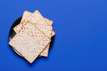 Plate with Jewish flatbread matza for Passover on color background