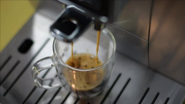Espresso machine making an espresso in a glass