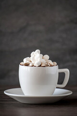 cup of coffee with marshmallows on a wooden table