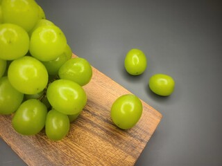 Grapes on wooden plates, dark background