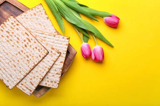 Jewish Flatbread Matza For Passover And Flowers On Color Background