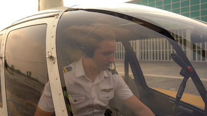 Business man and pilot in small private helicopter