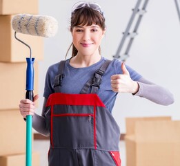 Woman painter painting in new apartment