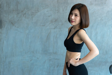 Close up asian beautiful sport girl on wall of gym,Thailand love health,Slim woman workout concept