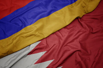 waving colorful flag of bahrain and national flag of armenia.