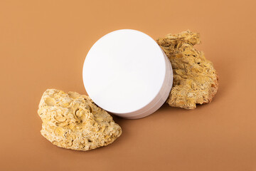 Blank round cosmetics container stay on the natural stones.Beatiful earth colors,concept of the...