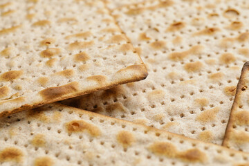 Jewish flatbread matza for Passover as background, closeup