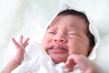 Asian beautiful newborn baby eating milk and wearing in white dress was sleeping on a white soft blanket, Infant, babyhood concept and copy space - Image