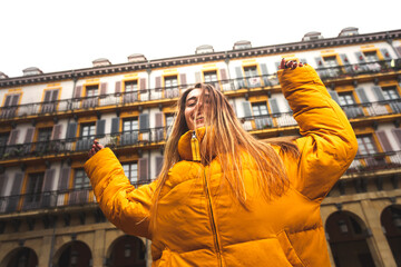 Portrait of a young caucasian brunette woman having fun at the street