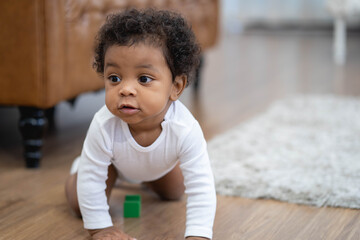 Happy African American Little baby boy crawling and looking for some thing to learn