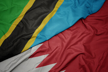 waving colorful flag of bahrain and national flag of tanzania.