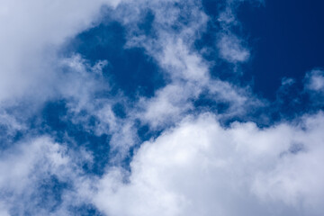 emerald blue sky with white fluffy clouds