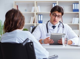 Female patient visiting male doctor for regular check-up in hosp