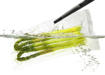 Asparagus in vacuum bag in water; isolated on white