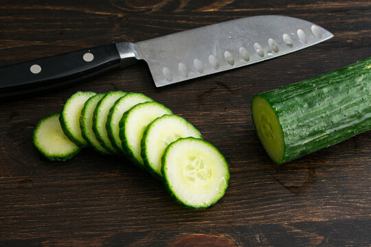 Slicing an English Cucumber: Slices of a seedless hothouse cucumber with a kitchen knife