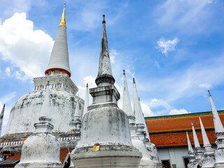 White ancient Pagoda or Chedi in Wat Phrathat temple in Nakorn Si Thammarat in Southern Thailand with cloud sky