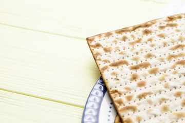 Jewish flatbread matza for Passover on wooden background, closeup